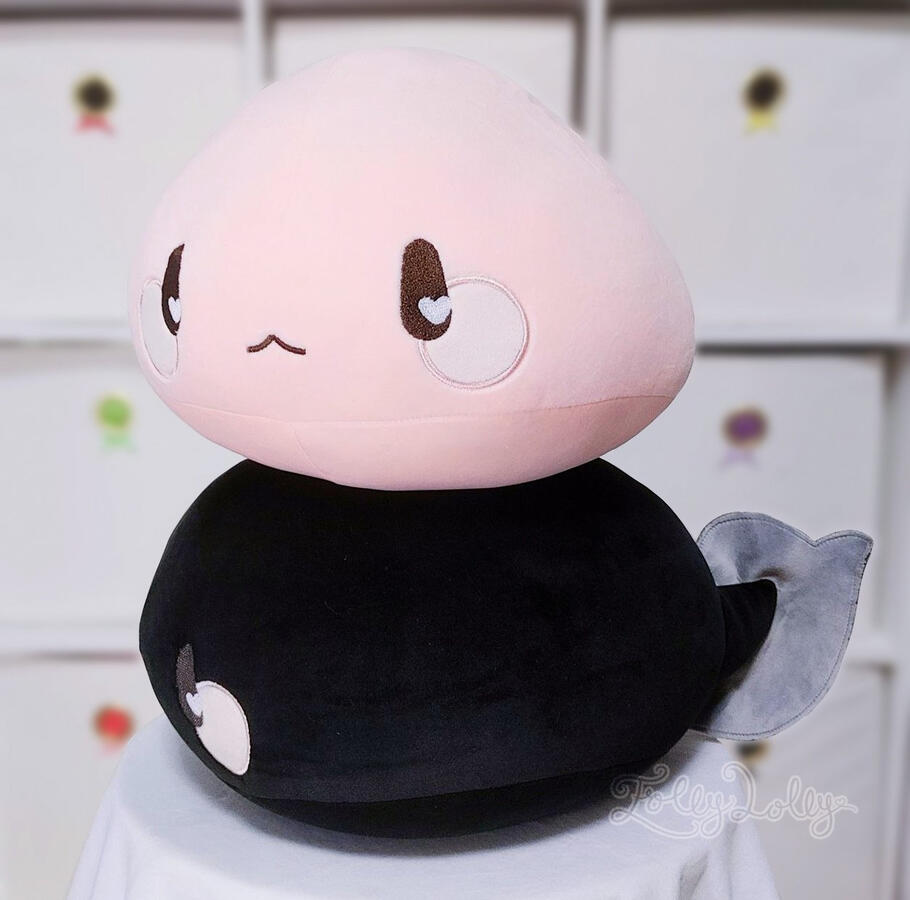 Pink and black tadpole plushies