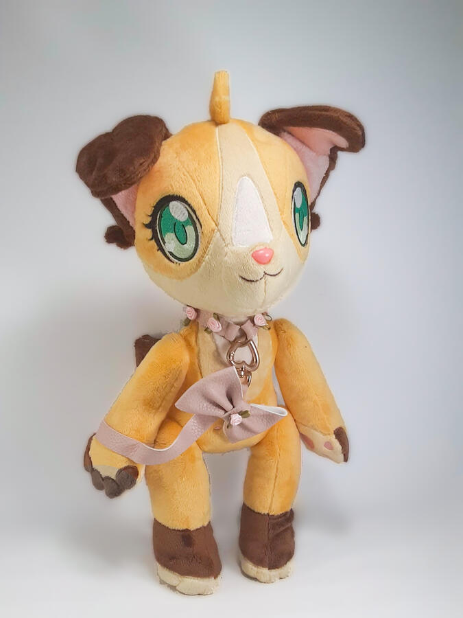 A jointed orange and brown anthro dog plush with a pink collar and leash