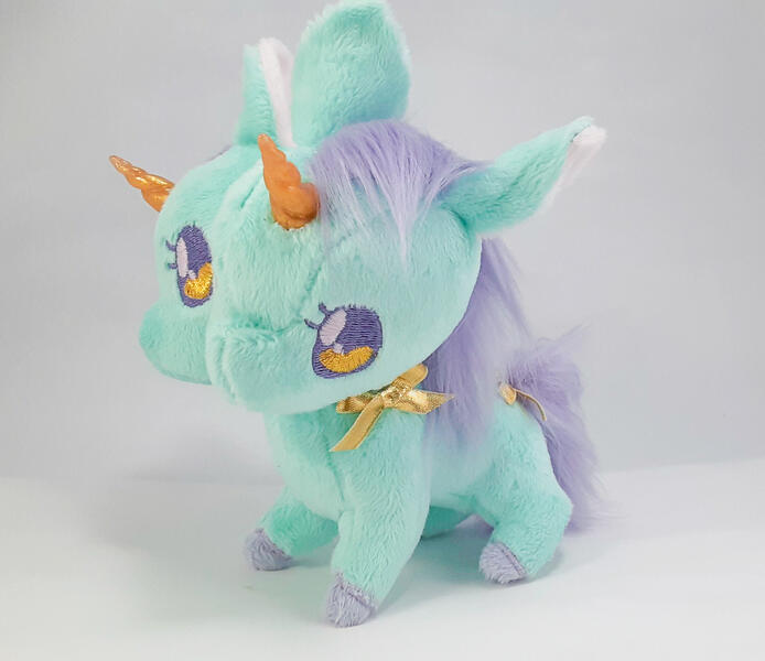 A mint green two-headed unicorn plush with gold and lavender accents