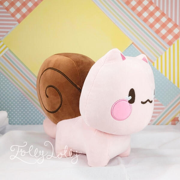 A pink snail-cat plush with a brown shell
